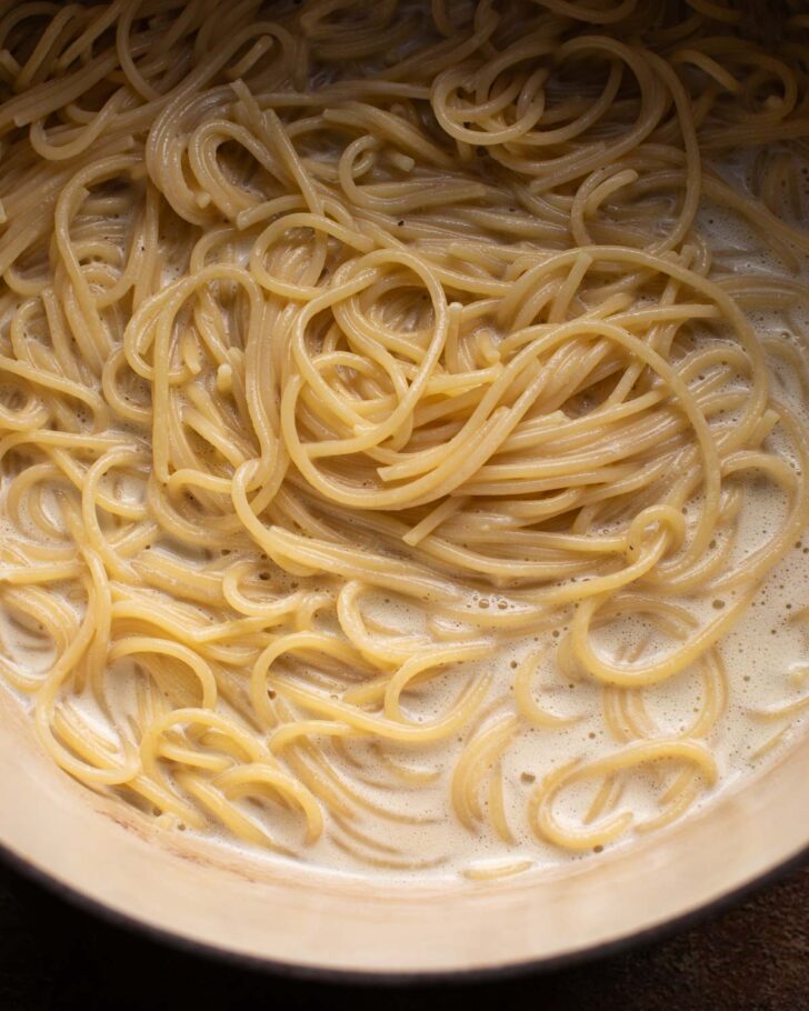 pasta combined with the sauce in the pot