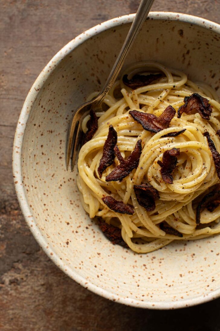 vegan mushroom carbonara in a bowl with a fork