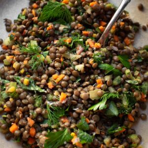 lentil salad on a plate with a fork