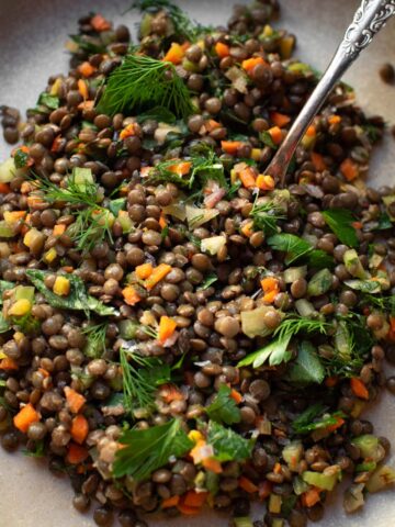 lentil salad on a plate with a fork