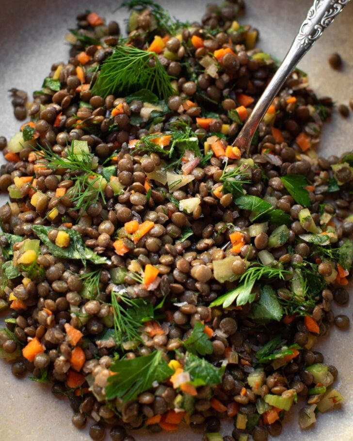 lentil salad on a plate with a fork