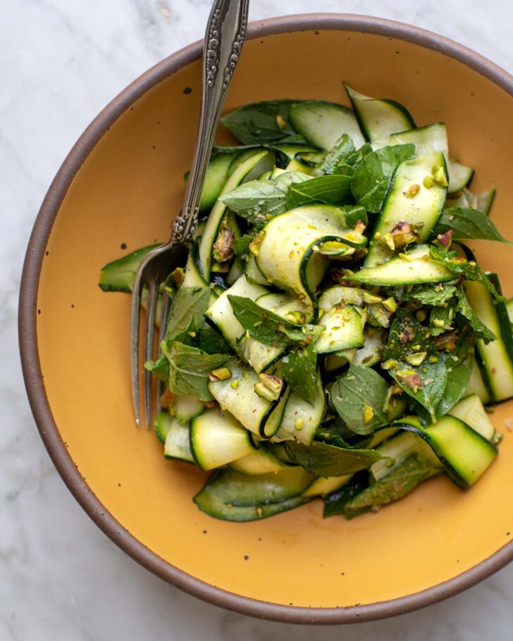 finished shaved zucchini salad in a bowl with a fork